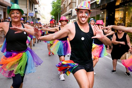 Santa Pola, Alicante, Spain- July 2, 2022: Group of dancers performing at the Gay Pride Parade in Santa Pola town, Alicante, Spain