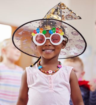 Shot of a little girl playing dress-up in class.