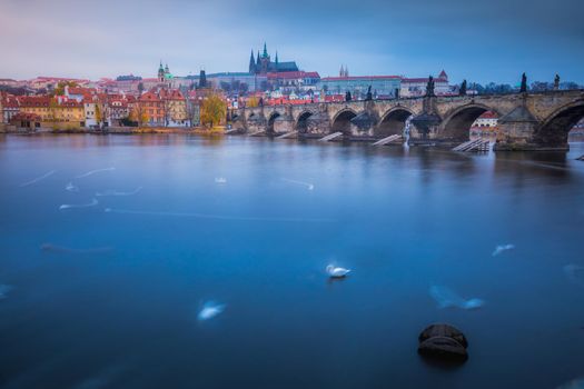 Blurred Vltava river, near Charles Bridge at evening - Prague, Czech Republic