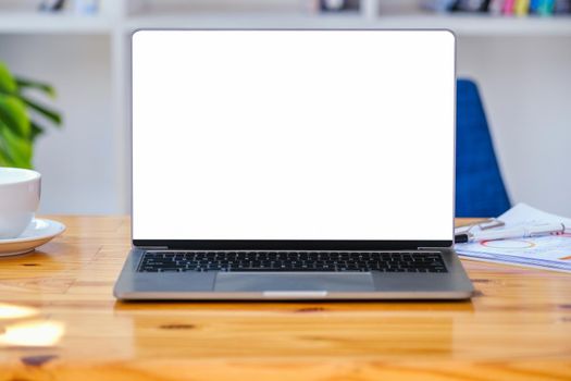 A white screen computer on a wooden table can carry text messages or images on a blank screen