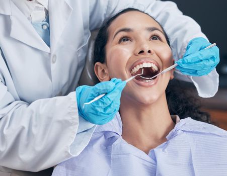 Shot of a young woman having a procedure performed by her dentist.