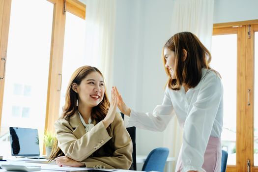 Young businesswoman collaborate with partners to increase their business investment network for Plans to improve quality next month in their office. agreement concept