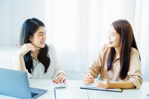 Negotiation, Analysis, Discussion, Portrait of an Asian woman economist and marketer pointing to a financial data sheet to plan investments to prevent risks and losses for the company.