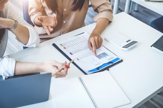 Negotiation, Analysis, Discussion, Asian woman economist and marketer pointing to a financial data sheet to plan investments to prevent risks and losses for the company.