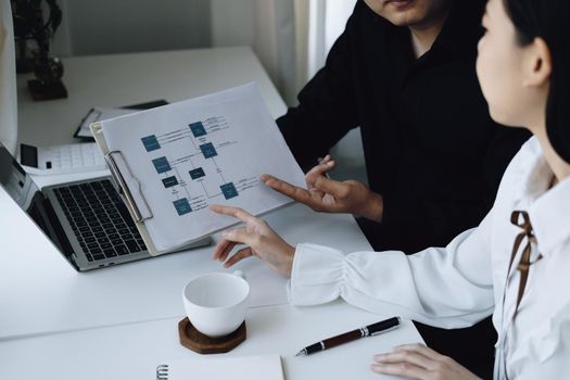 teamwork concept, consulting, male economist holding budget papers finance and investment Discuss and plan finances with a female marketer adviser in the conference room.