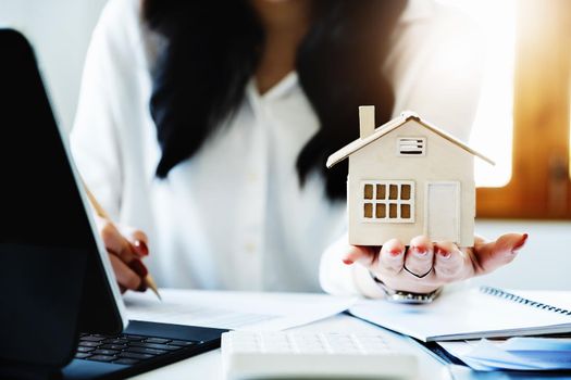 Entrepreneurs, business owners, accountants, real estate agents, focusing on tabletop home models with women using home equity budget calculators to assess their financial risks