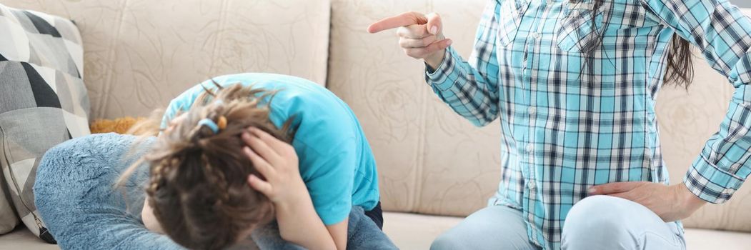 Portrait of millennial mother screaming shouting on little girl daughter. Complicated relations, misunderstanding conflict in family. Punishment concept