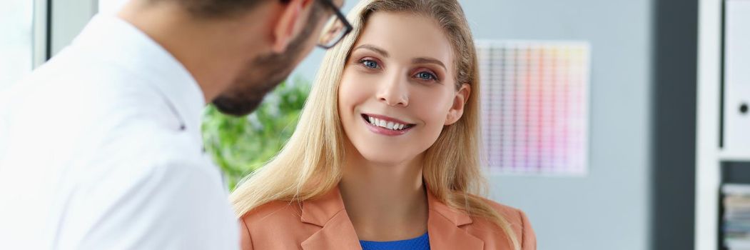 Portrait of businesspeople in office debate on financial issue, nice kind talk between colleagues. Woman clerk smiling posing. Business, corporate concept