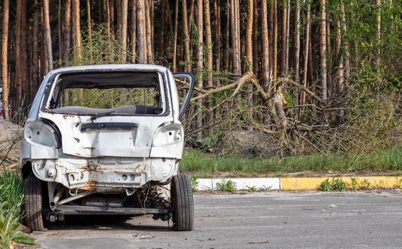 Broken minicar after a traffic accident in the parking lot of a repair station. Car body damage workshop outdoors. Sale of insurance cars at auction. Damage to the car body after the accident