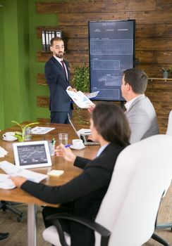 Business meeting and presentation in modern conference room for colleagues. Businessman in suit.