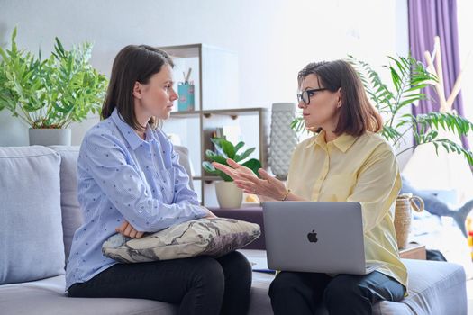 Young woman patient on individual therapy in psychologists office. Mature female counselor listening taking notes talking. Psychology, psychiatry, treatment, mental health concept