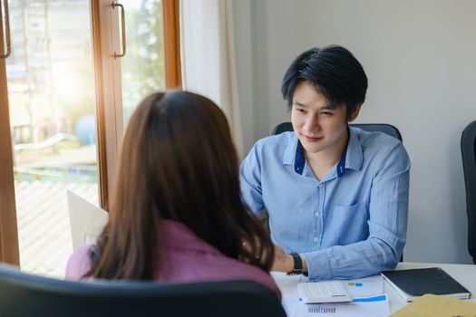 teamwork concept, consulting, portrait of male economist holding budget papers finance and investment Discuss and plan finances with a female marketer adviser in the conference room.