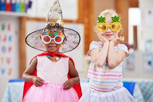 Shot of two girls playing dress-up in class.