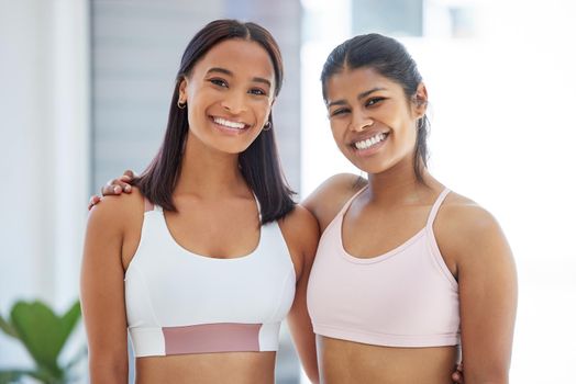 Portrait of two sporty young women in a yoga studio.