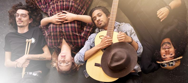 High angle portrait of a band lying on the stage after a gig.