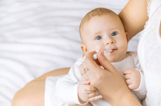 Mother gives medicine to baby for colic. Selective focus. People.