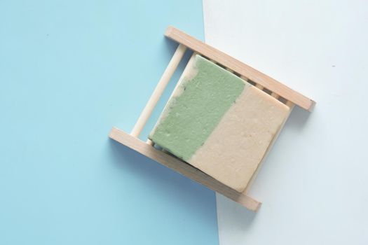 Homemade natural soap bar on black background .