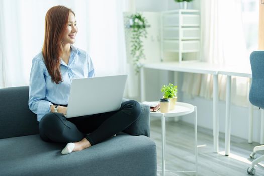 internet learning, online shopping, selling, meeting, information searching, Portrait of young Asian woman showing smiling face while using tablet to work at home