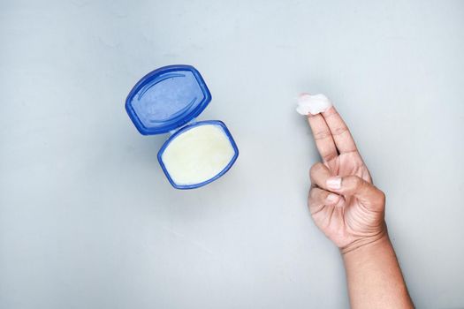 Close up of man hand using petroleum jelly .