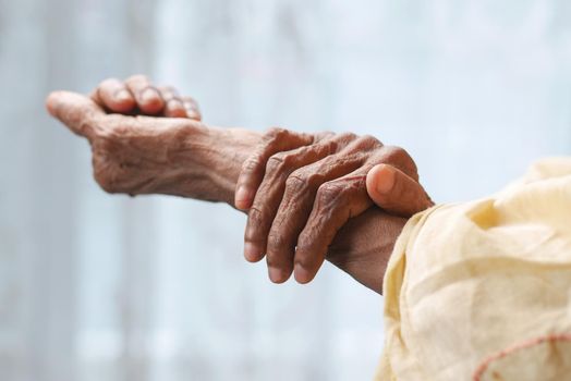 Elderly woman suffering from pain isolated on white.