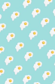 Broken egg on a light blue background. Pattern. Pop art