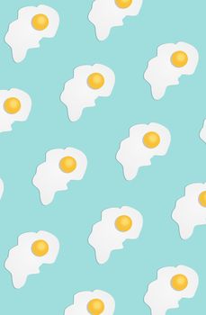 Broken egg on a light blue background. Pattern. Pop art