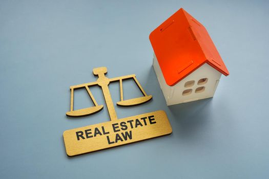 A Model of the house and a sign real estate law.