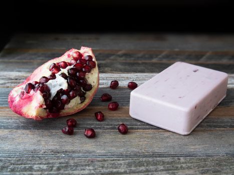 Pomegranate extract soap with a piece of a pomegranate.