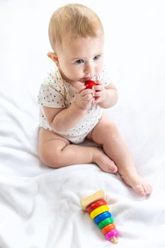 Baby plays with a pyramid at home. Selective focus. People.