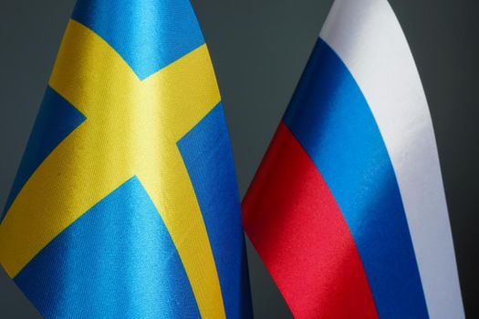 Closeup of the flags of Sweden and Russia.