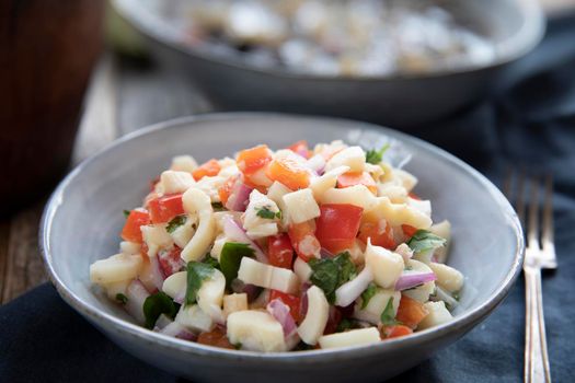 Vegan salad with hearts of palm, red onion, pepper, cilantro and lime dressing.