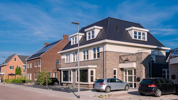 Dutch Suburban area with modern family houses, newly build modern family homes in the Netherlands, dutch family houses, and apartment houses. In the Netherlands, newly build streets with modern house