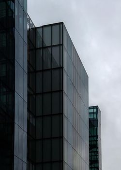 London, United Kingdom - October 22, 2006: Rectangle windows on glass and steel offices ("More London Estates" design by Foster and Partners) overcast sky in background.