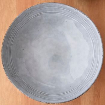 Empty blue bowl on wooden surface, image on of 8