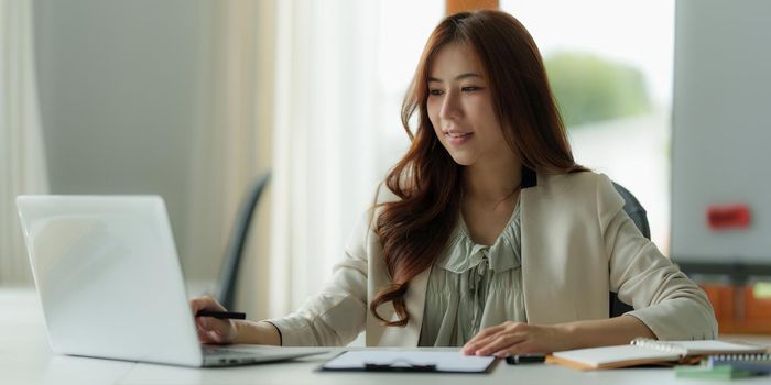 Image of Young business person working online on laptop computer. studying or working from home online concept