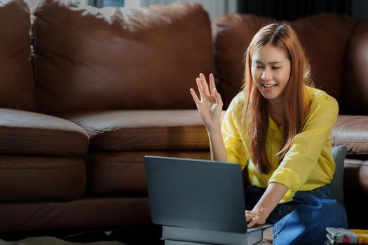 Young asian girl student watching online class by laptop. e-learning education concept