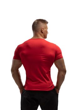 Portrait of an attractive athlete in a red t-shirt on a white cyclorama in the studio. Sports lifestyle.