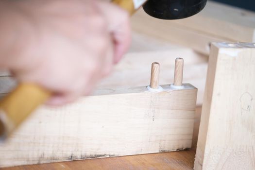 Focus on the woodwork, Entrepreneur Woodwork holding hammer to assemble the wood pieces as the customer ordered