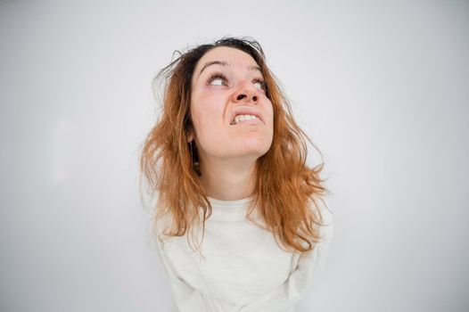 Close-up portrait of insane woman in straitjacket on white background