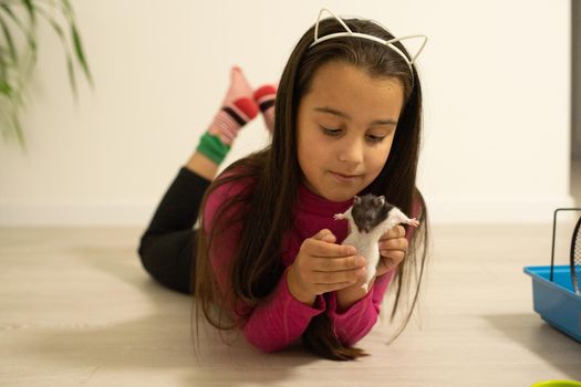 little girl holding a hamster