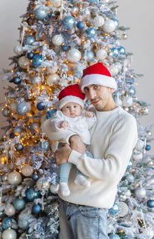 Christmas photo of a dad with a baby. Selective focus. Holiday.