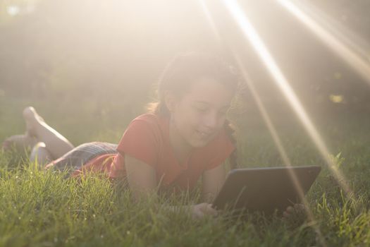 education, free time, technology and internet concept - little student girl with tablet pc.