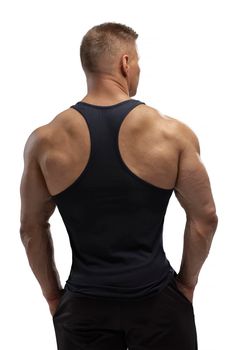 Portrait of an attractive athlete in a black tank top on a white cyclorama in the studio. Sports lifestyle.