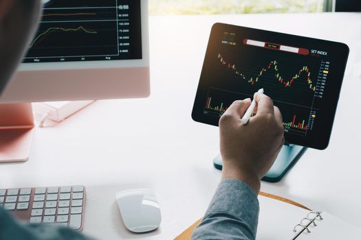 Business team working to analyze technical price graph and indicator. Chart and stock trading digital tablet.