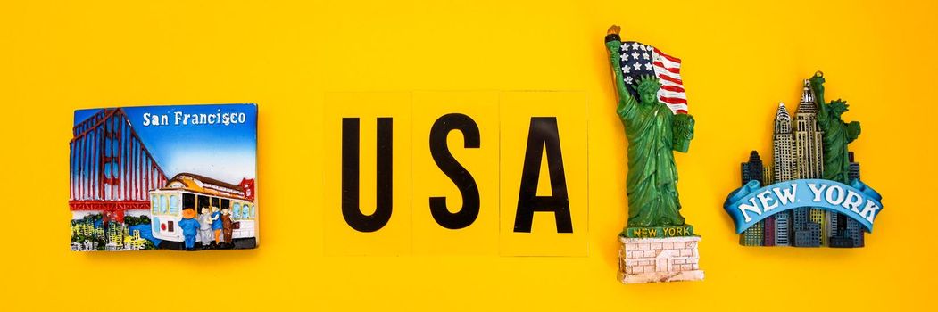 word USA with magnets from new york and san francisco on yellow background, travel destination, America travel