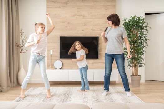 mother and daughter singing with hairbrushes