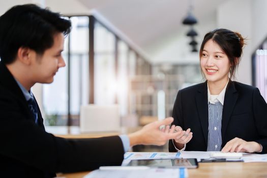Asian portrait of people working together on a new project to analyze budgets and manage investment risks in today's profit boosting for marketing in the office room.