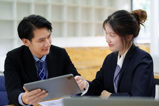 Asian portrait of people working together on a new project to analyze budgets and manage investment risks in today's profit boosting for marketing in the office room.