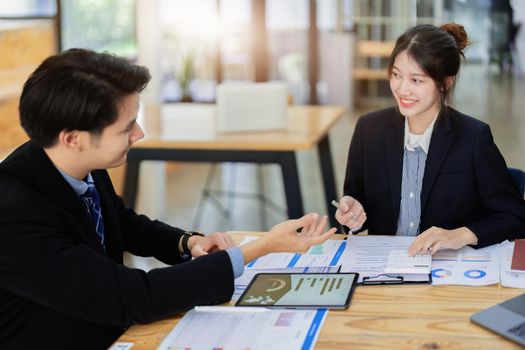 Asian portrait of people working together on a new project to analyze budgets and manage investment risks in today's profit boosting for marketing in the office room.