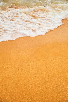 Top view over beach sea. Beautiful sea waves. Beach sand and amazing sea. Summer seascape. Water texture background.